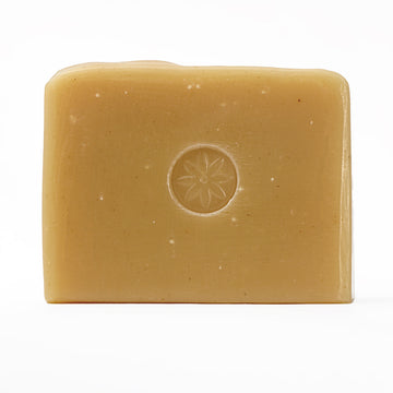 Tonic Mayer. Lemon Bar Soap, unwrapped, on an offwhite background.